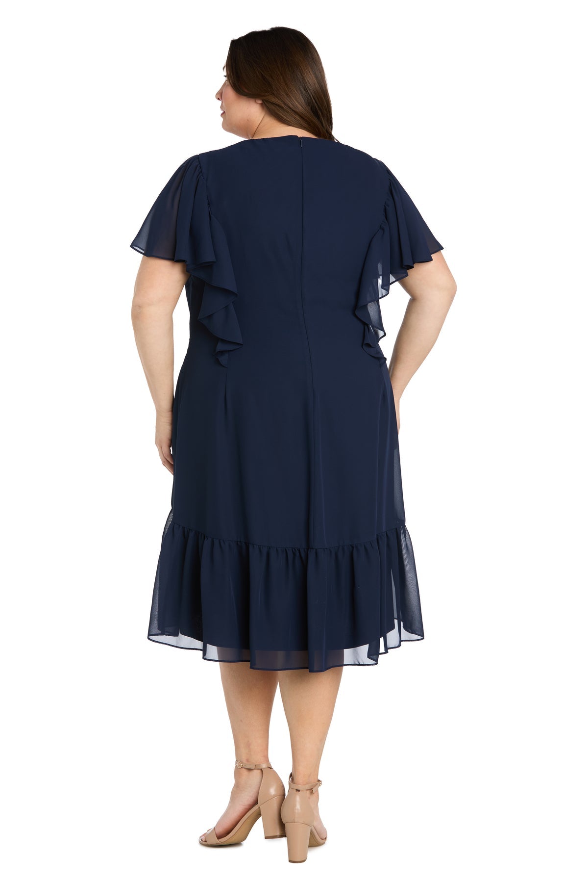 A woman is shown from the back wearing the R&M Richards 4054W Plus-Size Navy Party Dress with short ruffled sleeves and a ruffled hem, paired with nude heels.