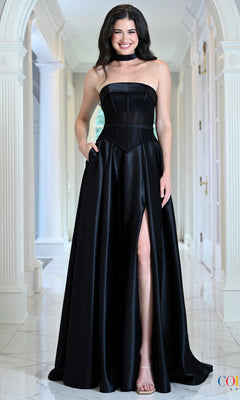 A smiling woman wears a Black Satin Prom Dress: Colors Dress 4056, featuring a strapless black corset bodice, a floor-length silhouette, and a side slit.