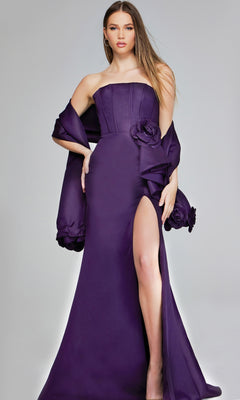 A woman poses elegantly in the Jovani 40592 long formal dress—strapless, deep purple with a thigh-high slit, floral accents, and a matching shawl—set against a plain light background.