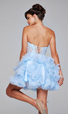 A woman stands sideways, looking over her shoulder, wearing the Short Homecoming Dress 40628 by Jovani—a strapless light blue dress with a sweetheart neckline, ruffle skirt, sheer lace corset bodice, and lace-up back.
