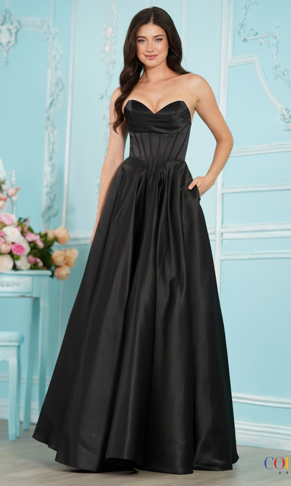 Long Prom Dress: Colors Dress 4063 in black, a floor-length A-line gown with a pleated sweetheart neckline, corset-style bodice, and side pockets.