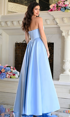 A woman wearing a light blue Colors Dress 4063 long prom dress, featuring a strapless, floor-length gown with a pleated sweetheart neckline and a corset-style bodice.