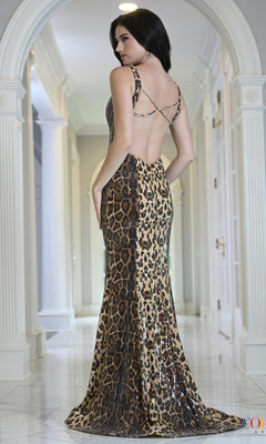 A woman wearing a Long Prom Dress: Colors Dress 4066, which is a backless, floor-length leopard print sequin gown.