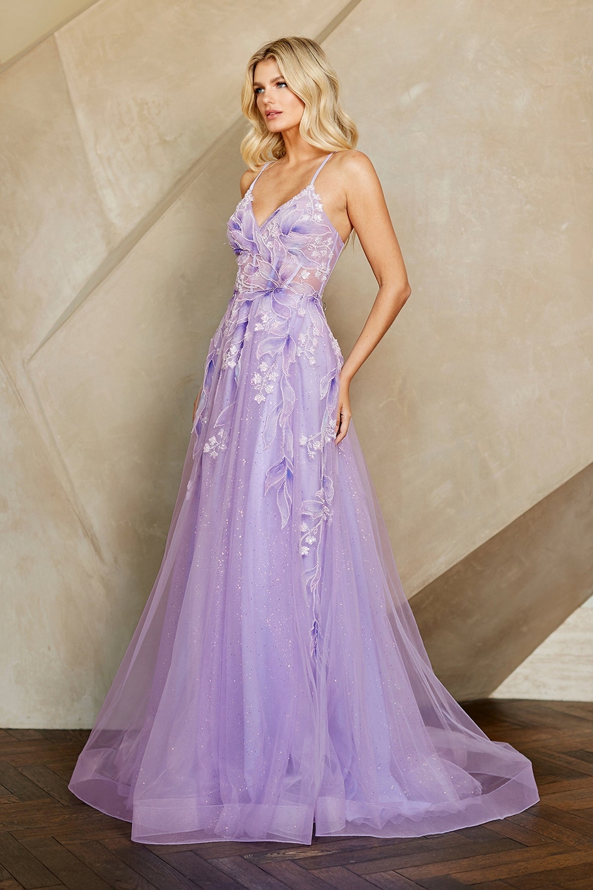 Amelia Couture 4073 floor-length lavender A-line evening gown with a V-neckline, thin straps, and sheer fabric overlays featuring embroidered floral and leaf appliqués.
