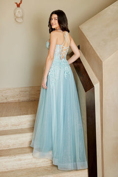 A person on a staircase wearing a light blue, floor-length lace appliqué Long Prom Dress: Amelia Couture 4074 with a lace-up back.