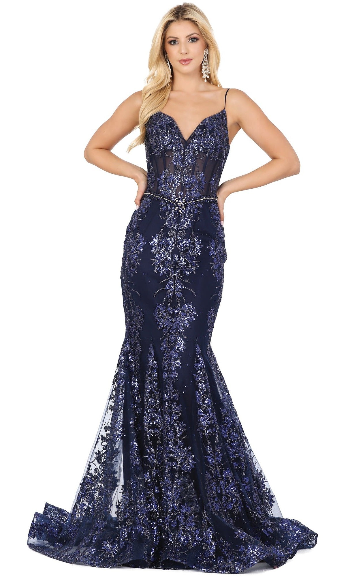 A woman stands with her hands on her hips, wearing the Long Sequined and Beaded Mermaid-Style Prom Dress in navy—a floor-length gown featuring a sweetheart neckline, thin straps, and elegant floral sequin embellishments. This dazzling mermaid-style dress beautifully highlights her silhouette, making her look unforgettable for prom night.