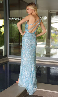 A woman stands by an indoor pool wearing the Primavera Strappy-Back Long Beaded Prom Dress 4124, featuring light blue beaded details and a strappy open back.