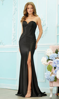 A woman wears a black Long Prom Dress: Colors Dress 4144, featuring a strapless corset bodice, a floor-length silhouette, and a high thigh slit.