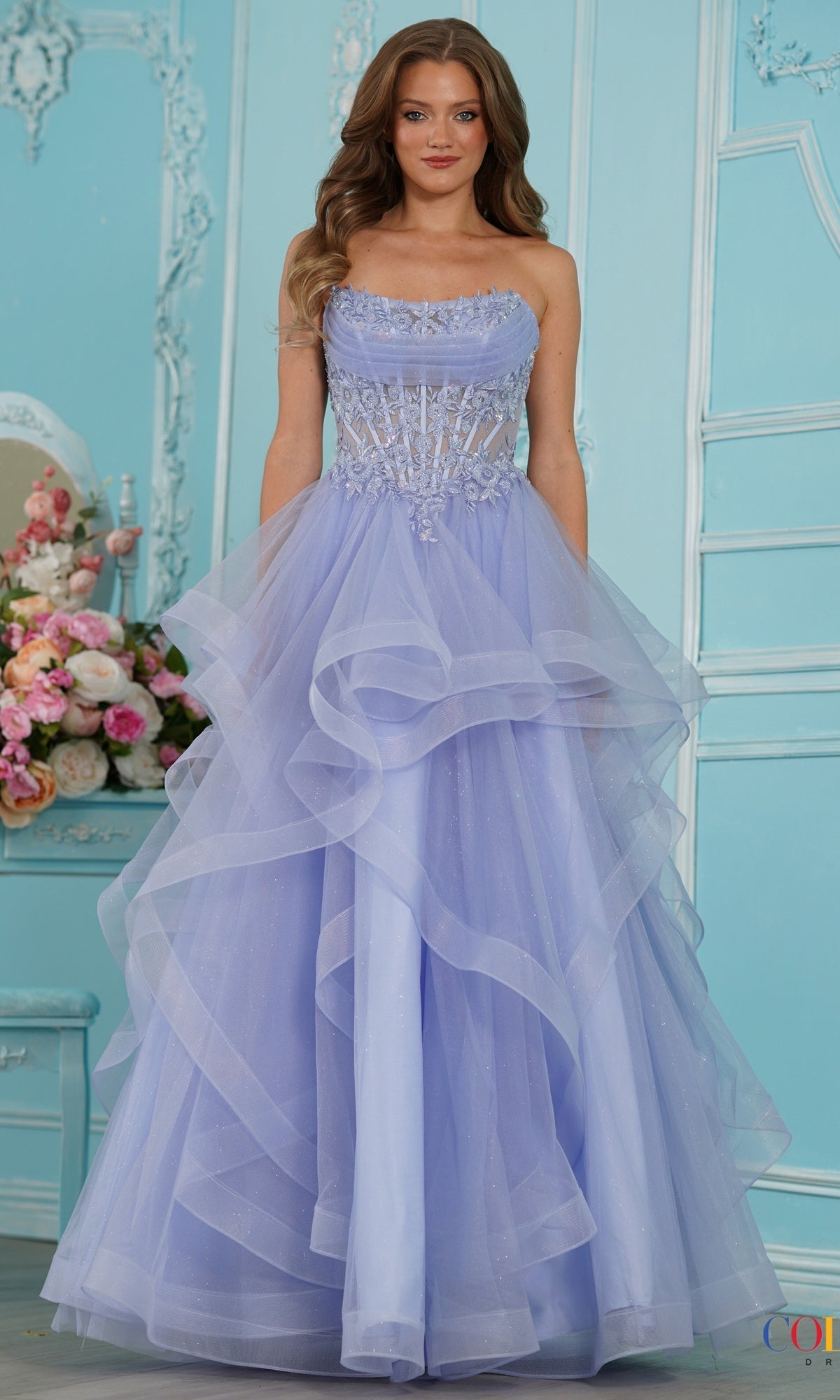 The Colors Dress 4151 is a strapless periwinkle princess dress with a lace corset bodice featuring floral embroidery and a full, layered tulle skirt.