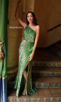A woman poses on tiled stairs in the Primavera One-Shoulder Long Beaded Prom Dress 4152, a stunning green sequined gown with a thigh-high slit and elegant one-shoulder design, perfect for prom night.