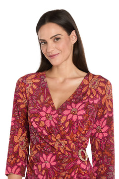 Woman with long dark hair wears the Red Knee-Length Party Dress: R&M Richards 4171, standing against a white background and facing the camera.