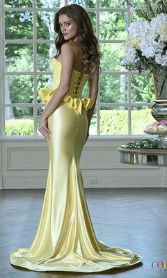 A woman wearing a floor-length yellow Long Prom Dress: Colors Dress 4181 featuring a corset bodice and a ruffled peplum detail.