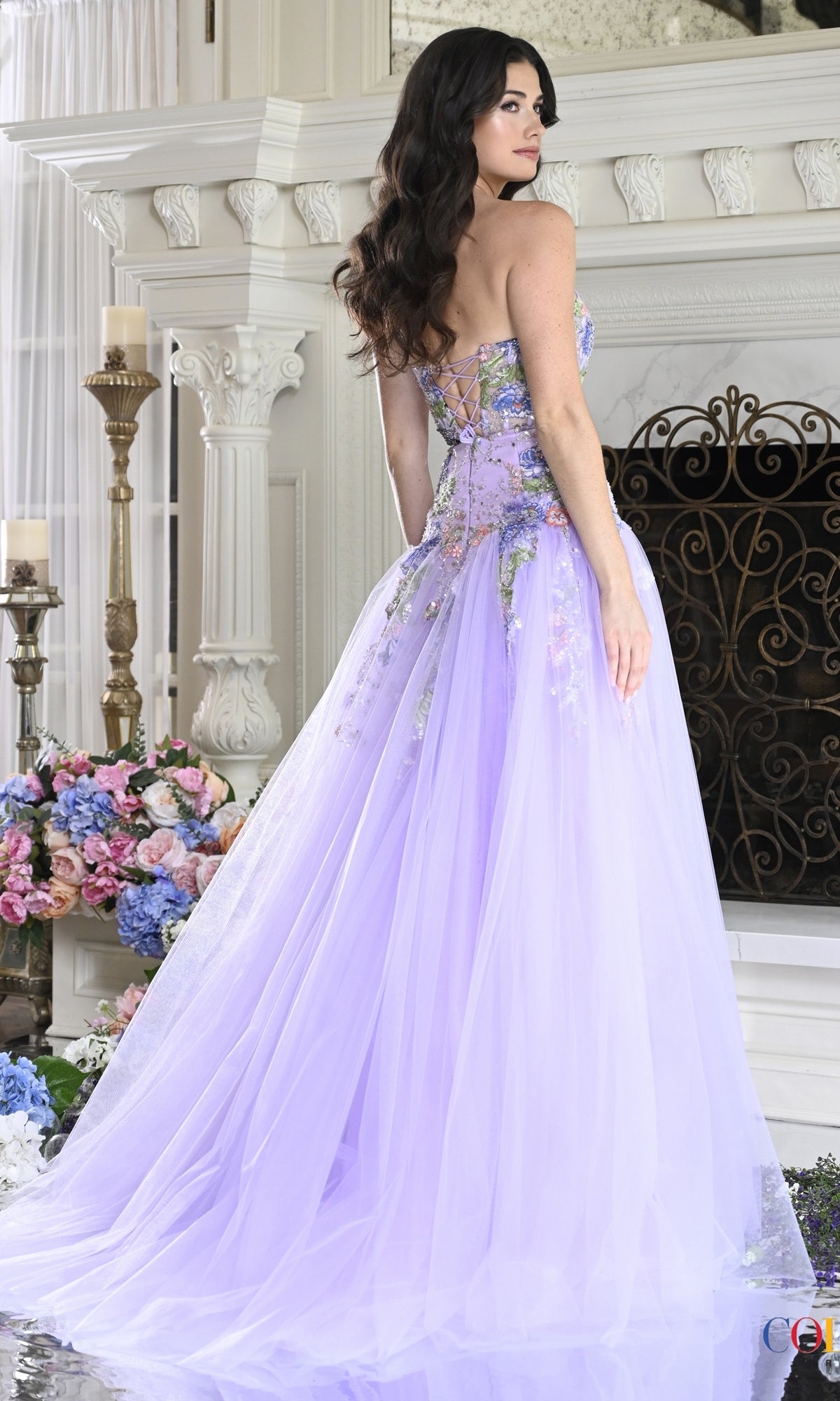 A lavender strapless Colors Dress 4199 fairy prom dress with a lace-up back and floral embroidery, shown from the back.