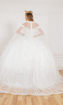 A person wearing the Quinceanera Dress 4201 by Cinderella Couture and a crown stands with their back to the camera in a bright, ornate room with wooden floors.