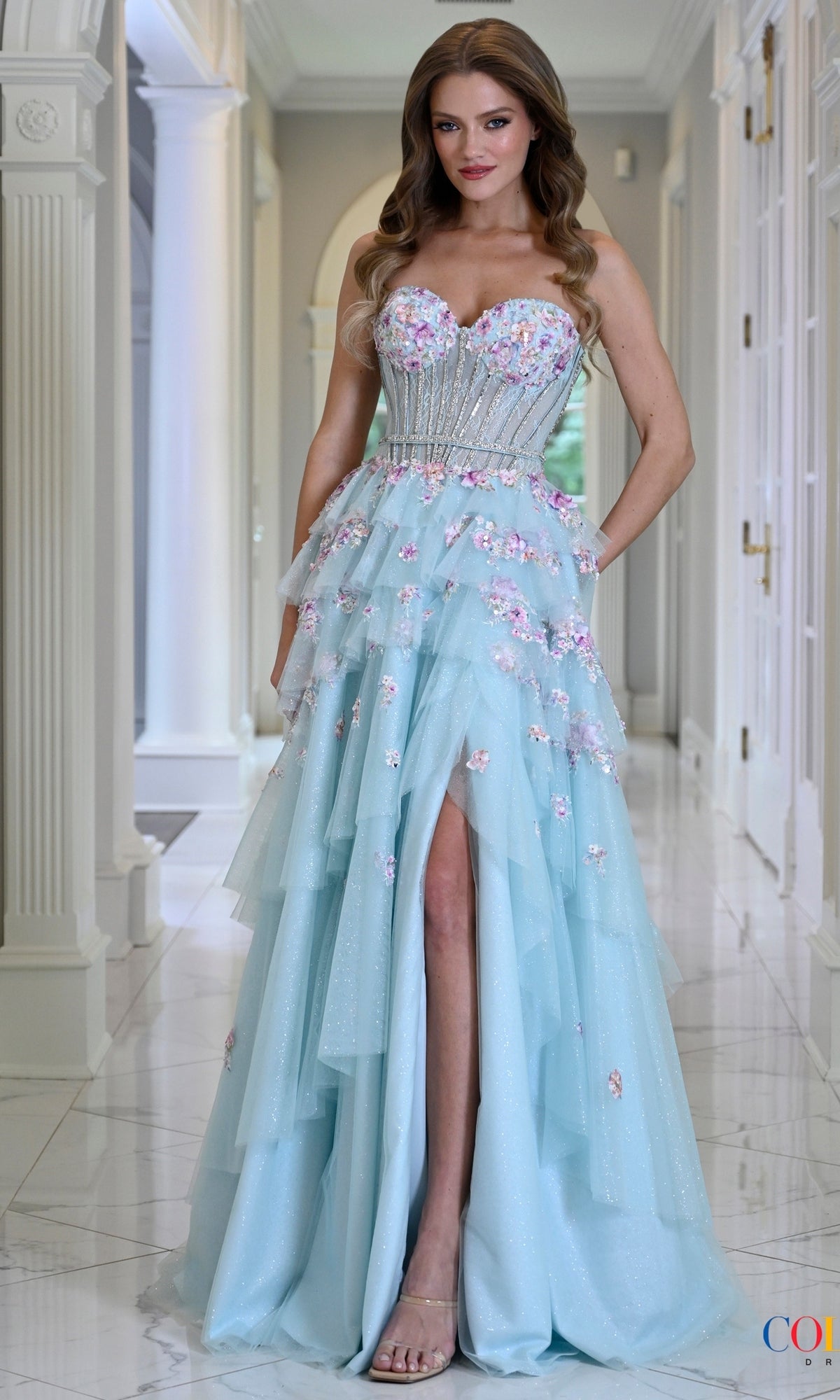 Colors Dress 4209 Tiffany light blue floral glitter tulle prom dress featuring a strapless corseted bodice, tiered skirt, and a high leg slit.