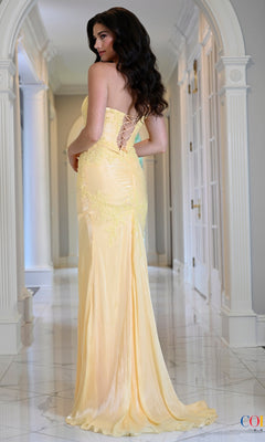 A woman wearing a Long Prom Dress: Colors Dress 4213, a draped, fitted, strapless floor-length yellow gown with a lace-up back design.