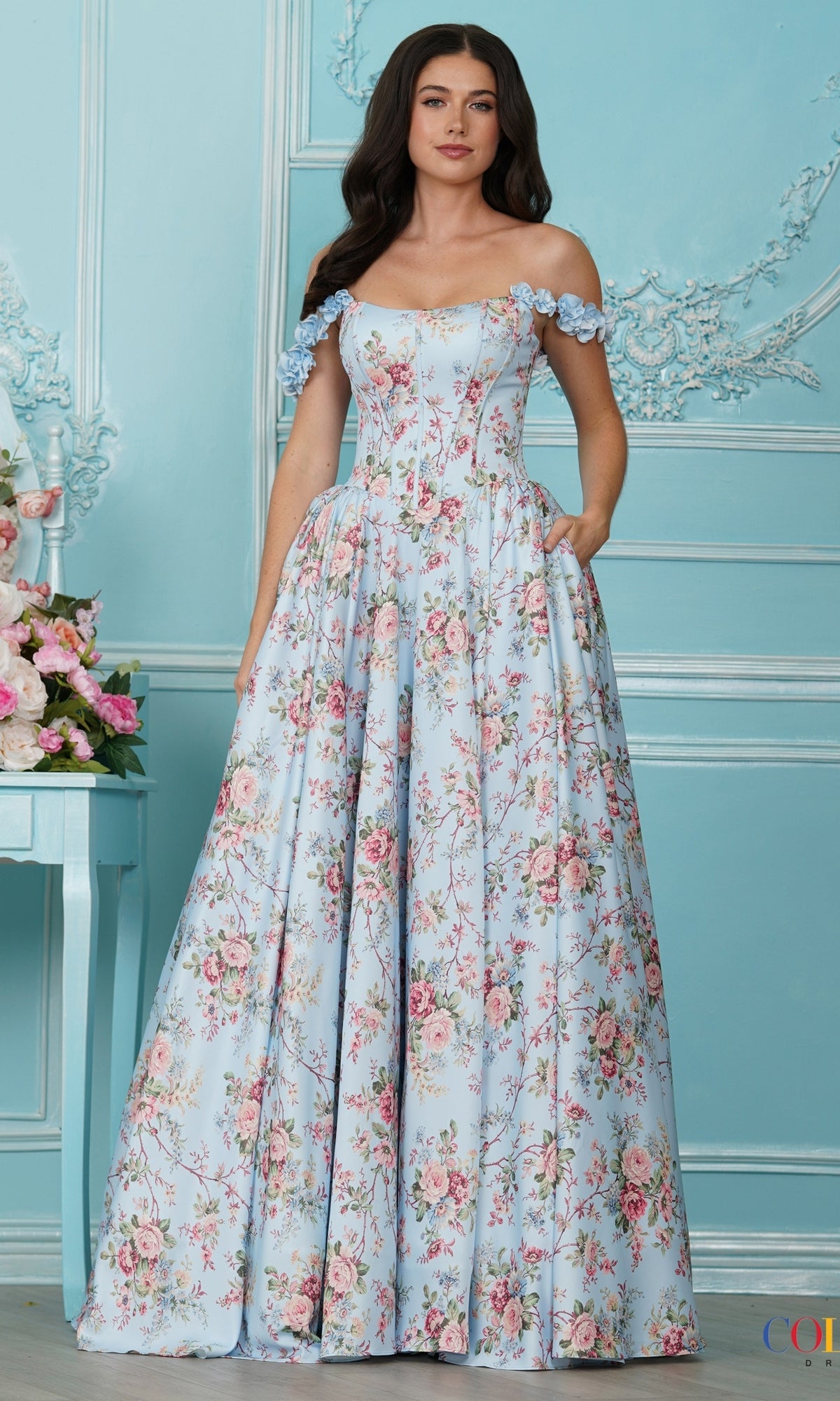 Long Prom Dress: Colors Dress 4214, an off-the-shoulder blue floral dress featuring a pink and green print with puff floral sleeves.