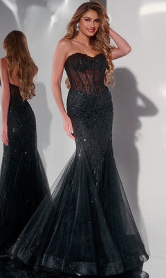 A woman poses elegantly in front of a mirror wearing the Jovani 42217 long prom dress—a strapless mermaid gown with a sheer corset bodice and dazzling sequin embellishments.