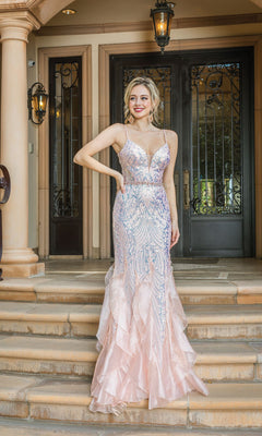 A woman in the Long Sequin Mermaid Prom Dress with Ruffles 4221—light pink, sleeveless, and floor-length—stands on stone steps before a grand double door entrance.