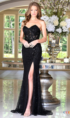 A woman wearing a black, strapless, floor-length Long Prom Dress: Colors Dress 4222 with a beaded bodice and a high side slit.