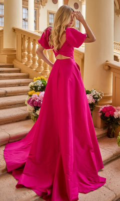 A woman wearing the Ava Presley 42269 puff-sleeve long prom dress stands on stone steps among flower arrangements, looking away from the camera.