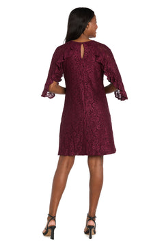 A woman faces away, wearing the R&M Richards 4226 short lace semi-formal dress in burgundy with ruffled sleeves and black heeled sandals—an elegant choice for special occasions.