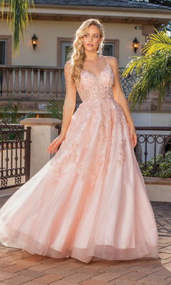A woman stands outdoors in front of a building with palm trees, wearing the Floral-Embroidered Long A-Line Prom Dress 4231 in light pink, featuring lace details and a fitted bodice.