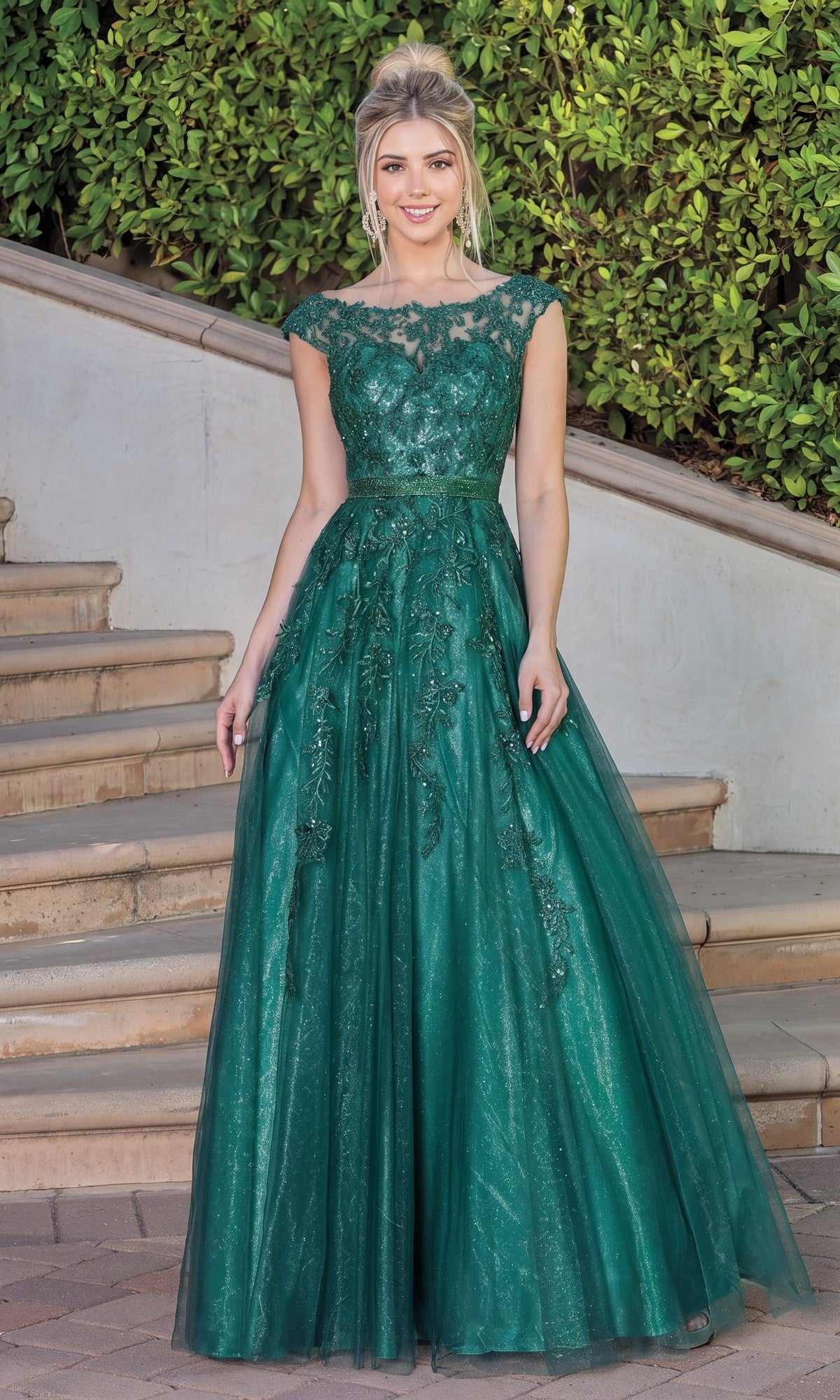 A woman stands on outdoor steps, greenery in the background, wearing the Corset-Back Illusion-Sweetheart Long Ball Gown in hunter green.