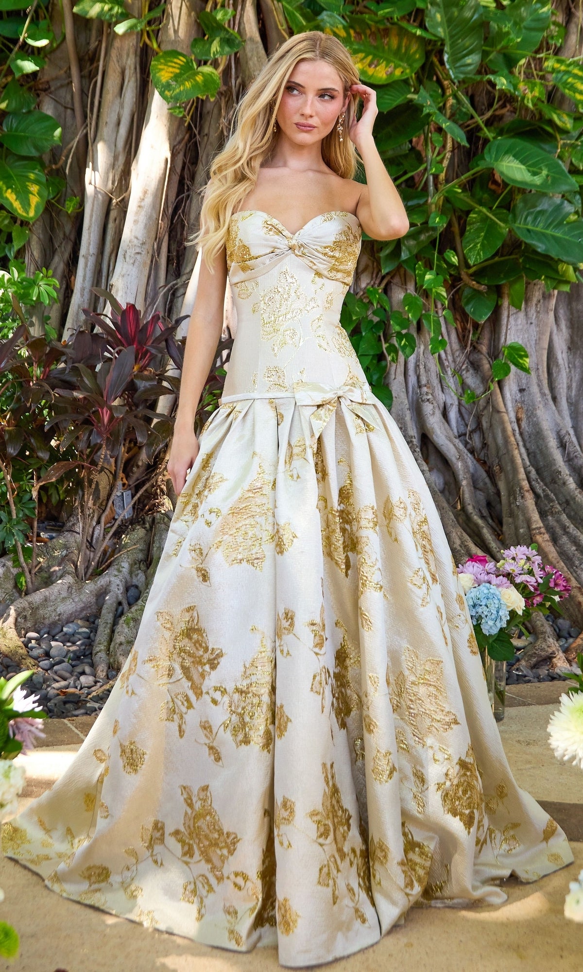 Ava Presley 42460 strapless gold floor-length ball gown with a sweetheart neckline and a metallic floral brocade pattern.