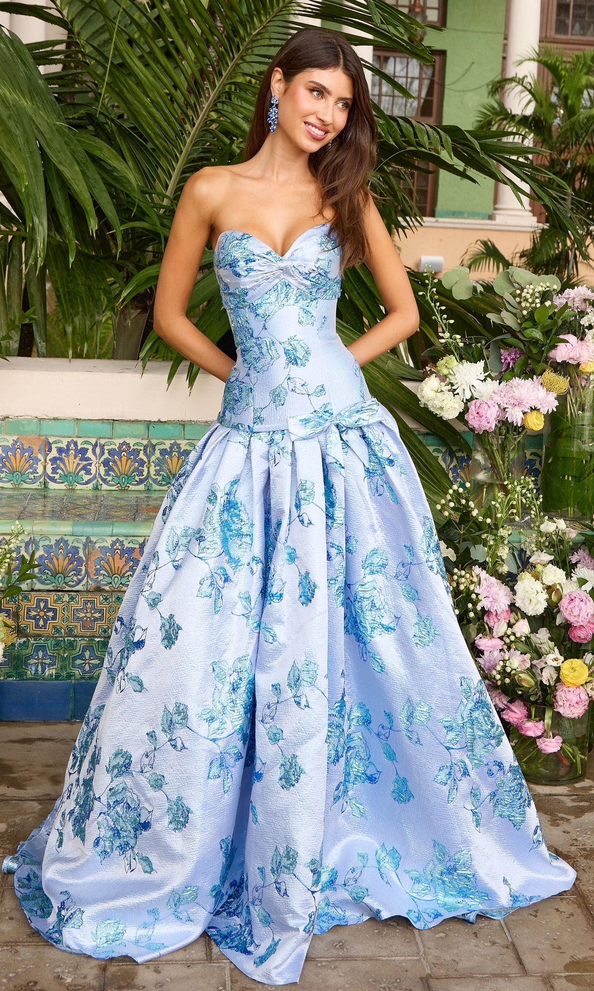 Strapless periwinkle Ava Presley 42460 ball gown with a sweetheart neckline and a blue metallic floral jacquard pattern.