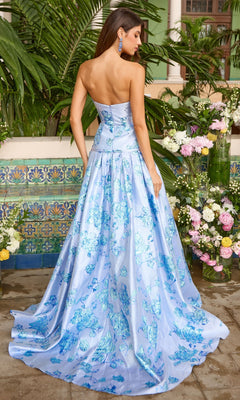 A woman wearing a Long Prom Dress: Ava Presley 42460, a strapless, floor-length light blue metallic floral gown.
