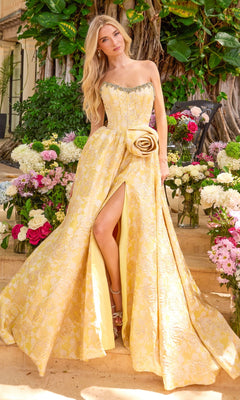 The Ava Presley 42517 long prom dress in soft yellow is a strapless floral gown featuring a brocade pattern, a large fabric rose at the waist, and a high front slit.
