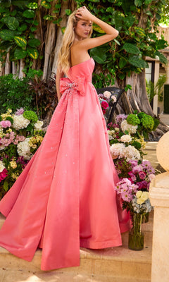 A strapless, floor-length pink Ava Presley 42523 ball gown featuring a large bow and scattered embellishments on the back.