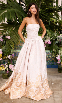 Ava Presley 42540 strapless ivory floor-length prom ball gown with a gold floral pattern at the hem.