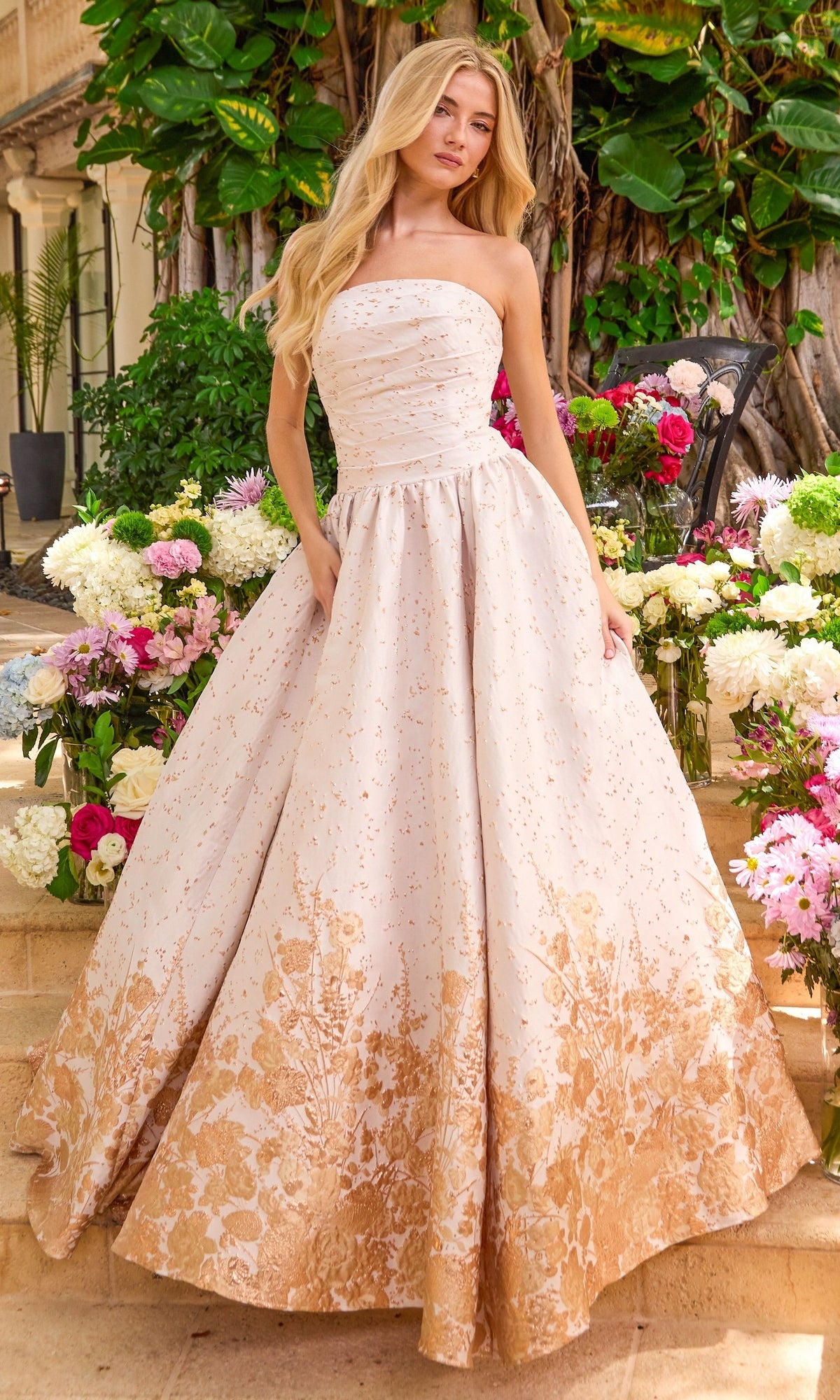 Strapless floor-length Ava Presley 42540 ball gown featuring a fitted bodice and a full skirt with a metallic gold floral print on the hem.