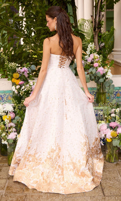 The Ava Presley 42542 long prom dress is a strapless, white, A-line gown featuring gold floral details and a lace-up corset back.