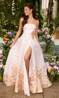 Strapless Ava Presley 42542 A-line gown with a thigh-high slit and gold floral print, featuring a three-dimensional floral accent at the waist.