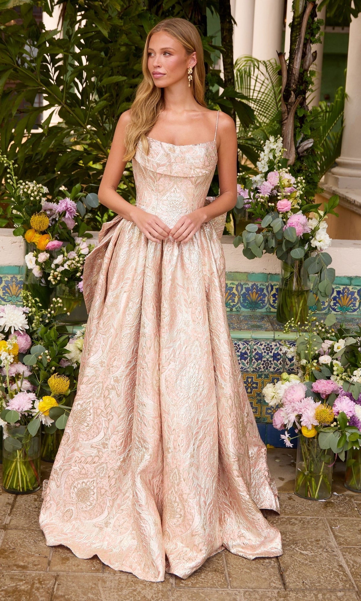 Ava Presley 42554 floor-length, light pink, sleeveless ball gown with a square neckline and a full, metallic floral patterned skirt.