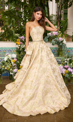 Long Prom Dress: Ava Presley 42555, a strapless, floor-length ball gown featuring an intricate gold floral pattern over a beige base with a thin embellished belt at the waist.