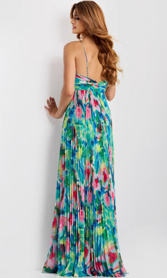 A woman with long, wavy hair models the Jovani 42558 Long Prom Dress—a floor-length, strappy gown with a colorful abstract floral print—photographed from the back against a plain light background.