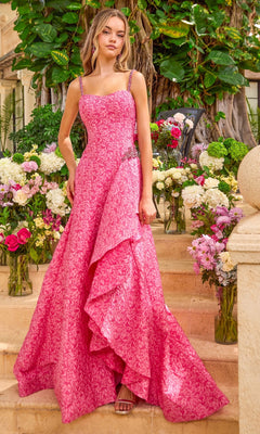A hot pink patterned Ava Presley 42577 A-line prom dress with beaded straps and a side-slit skirt, standing amidst floral arrangements.