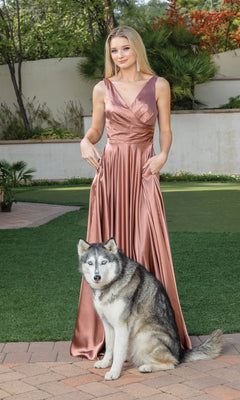 A woman wearing the Wrap-Bodice Long A-Line Prom Dress 4262 stands outdoors on the grass, with a husky dog sitting in front of her.