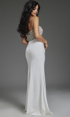Model showcases the Jovani 42637 long prom dress, featuring a strapless design with a beaded bodice and high leg slit, standing slightly turned against a plain gray background.