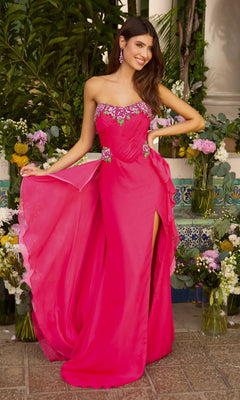 A woman wears a hot pink Ava Presley 42650 strapless, flowy prom dress with a floor-length silhouette, a side slit, and floral embellishments on the bodice.
