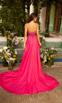 A person seen from behind wearing an Ava Presley 42650 strapless, fuchsia floor-length gown with a beaded bodice and a full skirt with a train.
