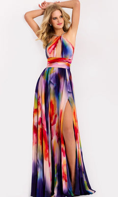 A woman poses in the Jovani 42717 Long Prom Dress, a colorful sleeveless gown with a halter neckline, pleated floor-length skirt, high slit, and flowing silhouette against a plain white background.