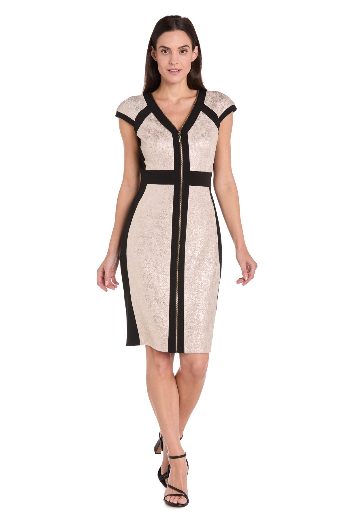 A woman wears the R&M Richards 4272 Short Champagne Party Dress with black trim and a front zipper, paired with black strappy heels, walking forward against a white background.