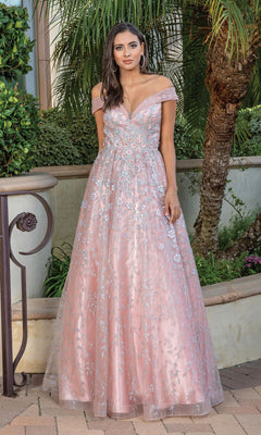 A woman stands outdoors before greenery, wearing the Long Formal Dress 4273—a floor-length pink glitter floral ball gown with embroidered details, off-the-shoulder neckline, and a full skirt.