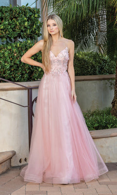 A woman stands outdoors in the Long A-Line Tulle Prom Ball Gown with Flowers 4276—a light pink dress featuring thin straps and 3-D floral designs on the bodice. She has long, straight blonde hair.
