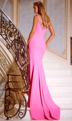 A woman wearing the Bead-Trimmed Long V-Back Prom Dress: Jovani 42899 stands on a curved staircase with ornate railings, facing away from the camera.